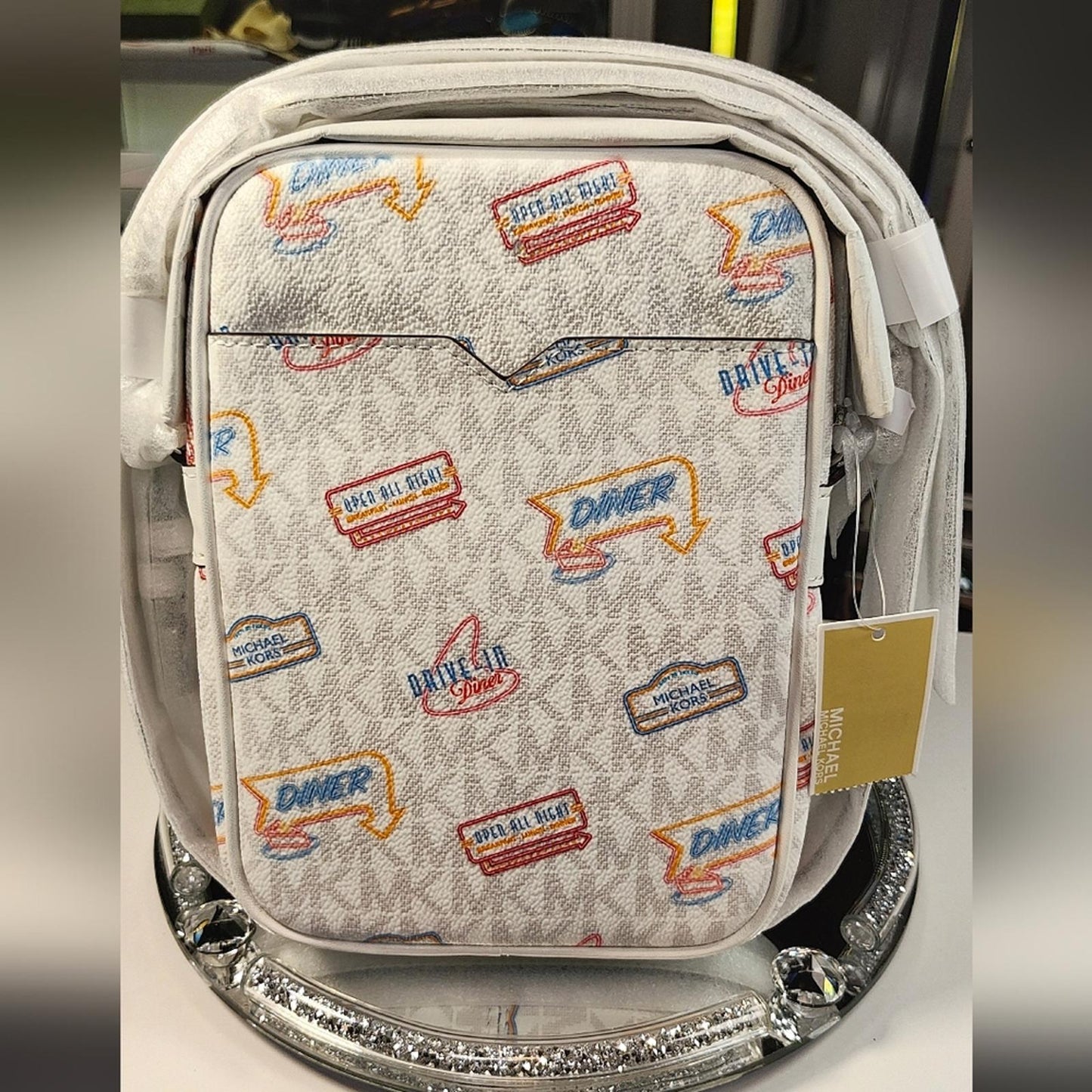 Michael Kors Jet Set Travel Medium Crossbody Bag with a diner-themed signature