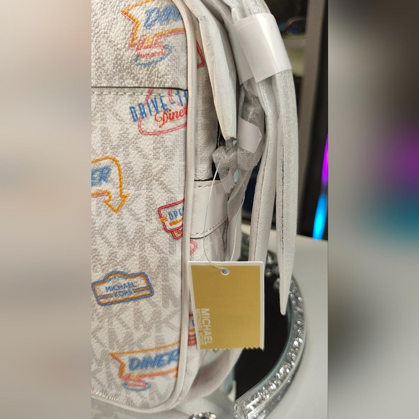 Michael Kors Jet Set Travel Medium Crossbody Bag with a diner-themed signature
