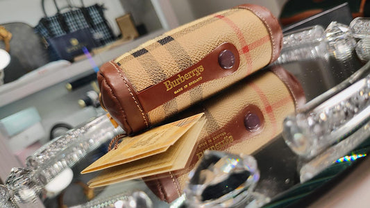 Burberry wallet on a reflective surface with blurred background